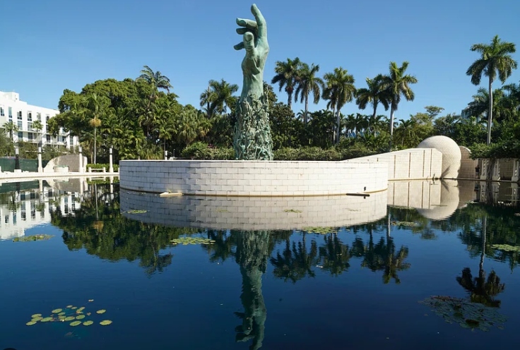 The Holocaust Memorial of Miami Beach — Kenneth Treister’s bronze sculpture of a hand reaching skyward, rising from a reflecting pool ringed by palms and Jerusalem-stone walls.