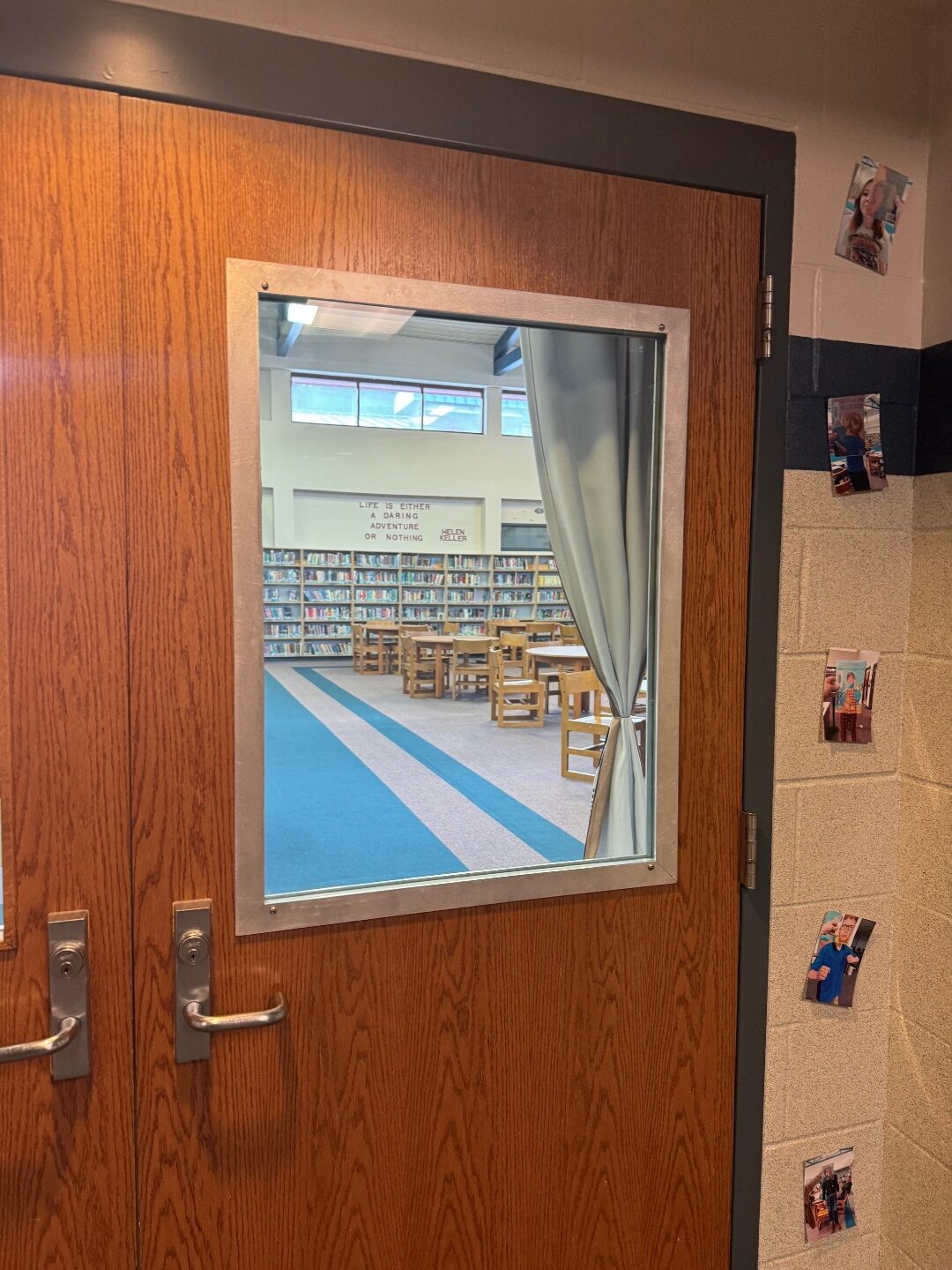 RetroKIT installed in a 33 by 25 inch library door vision lite at an Indiana high school. Original wood door retained, aluminum frame trim around the new ballistic glass.