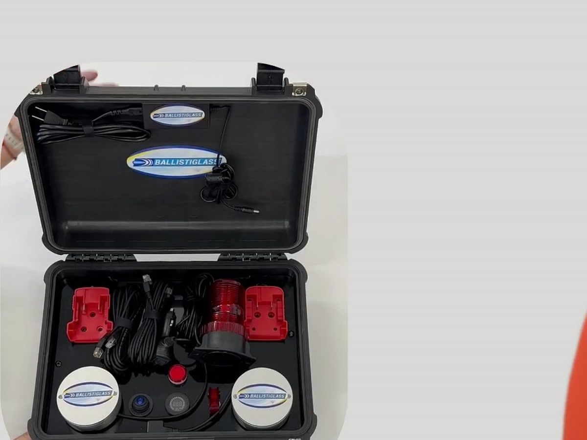 BallistiSCAN V3 field kit in the open Pelican case, showing the two hockey-puck-sized sensor discs with the Ballistiglass logo, alongside mounting brackets, cabling, alarm tower, and controls.