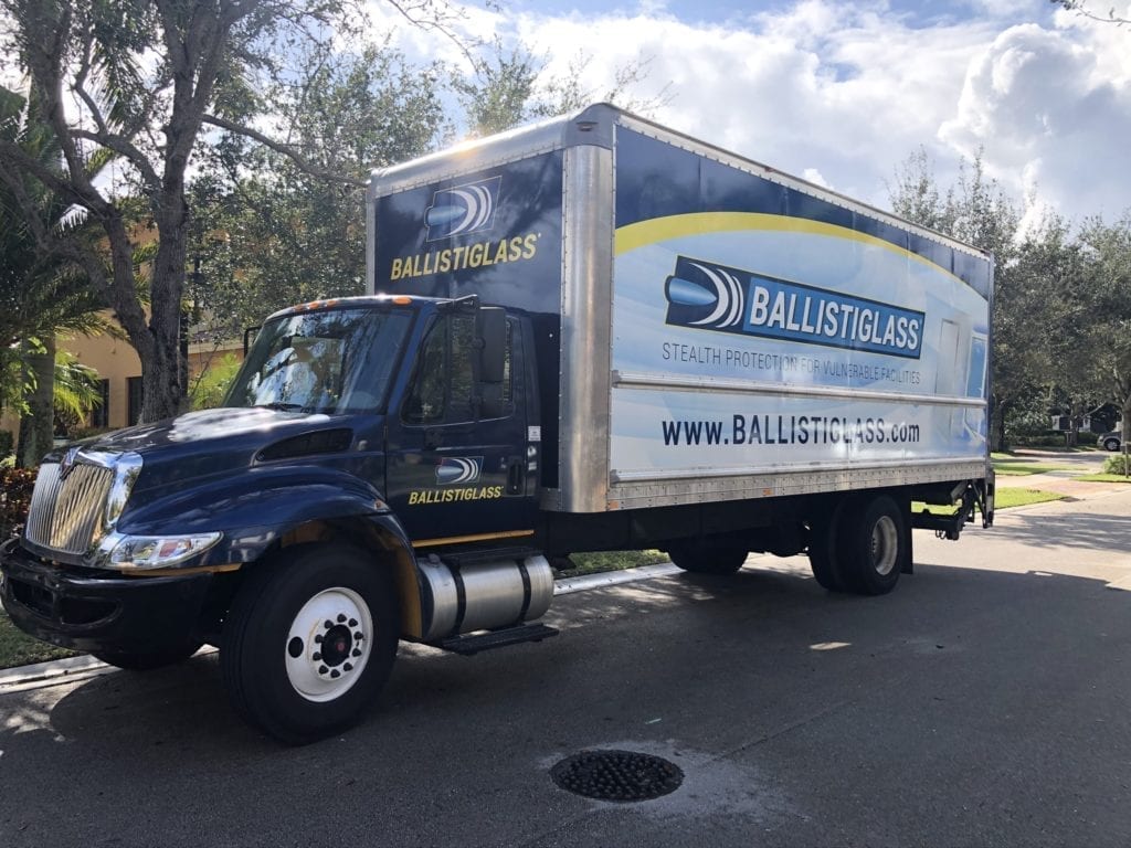 Blue Ballistiglass Truck Parked On A Road